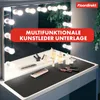 A vanity mirror with lights and makeup products on a desk, with a dark desk mat. Anteprima dell’immagine prodotto