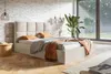 A bedroom scene with a bed, side table, and large window. Náhled obrázku produktu