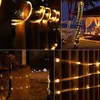 Collage of images showing warm white LED string lights wrapped around fences, trees, and wooden posts in outdoor settings at night. Produktbild-Vorschau