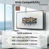 A TV wall mount is shown attached to a TV on a wall, with text overlays indicating compatibility and VESA patterns. The background shows a living room setting with a large window overlooking the sea. Produktbild-Vorschau