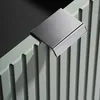 A close-up shot of a chrome handle attached to a light green ribbed surface, possibly a radiator or cabinet. Produktbild-Vorschau