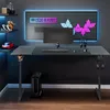 A gaming desk setup with a computer, monitor, keyboard, headphones, and decorative lighting. Náhled obrázku produktu