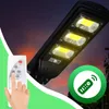 A solar street lamp with a remote control, set against a twilight sky. Anteprima dell’immagine prodotto
