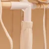 A close-up view of a white plastic connector and a wooden rod, with beige fabric hanging down. Produktbild-Vorschau