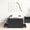 A black bed frame with two open drawers is shown in a bedroom setting with two abstract paintings on the wall and a nightstand with an alarm clock on the right. Podgląd zdjęcia produktu