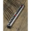 A power strip with multiple outlets and plugs is laid out on a wooden surface. Produktbild-Vorschau