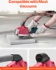 A person wearing gloves is using a red angle grinder with a dust collection attachment on a piece of material. Voir les images du produit