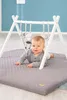A baby is playing on a mat under a play gym. Náhled obrázku produktu