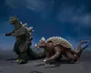 Two monster action figures, Godzilla and Anguirus, posed on a dark, textured surface against a cloudy blue sky. Náhled obrázku produktu