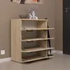 A modern shoe cabinet with four flip-down doors in a light wood finish, placed against a neutral wall. Podgląd zdjęcia produktu