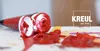A close-up of a red paint tube with paint splattered on a surface, with the brand name KREUL and the founding year visible. Podgląd zdjęcia produktu