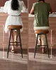Two people sitting on bar stools at a counter. Produktbild-Vorschau