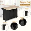 A kitchen cart with a drop-leaf tabletop is shown in a kitchen setting, with instructional steps for folding the tabletop. Podgląd zdjęcia produktu
