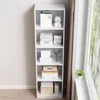A tall, narrow white bookshelf filled with various items, placed next to a window with a view of greenery. Produktbild-Vorschau