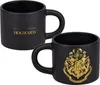 Two black mugs with gold Hogwarts crests and text, displayed against a white background. Náhled obrázku produktu
