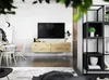 A modern living room with a wall-mounted TV, wooden media console, shelving unit, and dining area. Produktbild-Vorschau