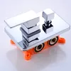 A chrome shower faucet with an orange plastic mounting box. Produktbild-Vorschau