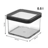 A clear, studio shot of a transparent square food storage container with a black lid, showing its dimensions. Produktbild-Vorschau
