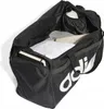 An open black duffel bag with clothing and a water bottle inside, with the Adidas logo visible on the side. Produktbild-Vorschau