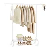A white garment rack with various neutral-colored coats and a straw hat. Náhled obrázku produktu