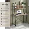 A tectake home desk with a laptop, mug, and notebook on it, set against a green wall. Náhled obrázku produktu