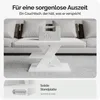 A white coffee table with a 50kg weight on it, placed in a living room setting with a sofa in the background. Produktbild-Vorschau