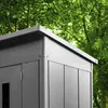 A close-up view of the corner and roof of a gray metal garden shed, with lush green trees in the background. Anteprima dell’immagine prodotto