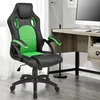 A gaming chair is positioned next to a desk with a computer. Podgląd zdjęcia produktu