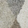 A close-up view of a textured rug with a geometric pattern. Produktbild-Vorschau