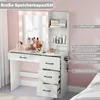 A white vanity table with a mirror and drawers, featuring various cosmetic products and a hairdryer. The image includes text overlays highlighting product features. Voir les images du produit