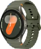 A close-up, studio shot of a smartwatch with a green silicone band. Náhled obrázku produktu