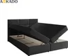 A black boxspring bed with its storage compartments open, revealing the interior. Náhled obrázku produktu