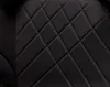 A close-up view of the quilted black fabric of a car seat. Náhled obrázku produktu