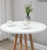A white round table with two coffee cups and a vase of flowers. Podgląd zdjęcia produktu