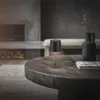 A dark, modern living room with a fireplace and a wooden coffee table. Náhľad obrázku produktu