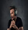 A man wearing headphones against a dark background. Produktbild-Vorschau