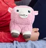 A pink plush toy sheep is held by a person. Produktbild-Vorschau