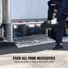 A person is placing a toolbox into an open underbody truck box mounted on the side of a truck. Anteprima dell’immagine prodotto
