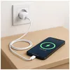 A smartphone is charging on a wooden surface, connected to a wall adapter. Anteprima dell’immagine prodotto