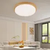 A modern living room with a sectional sofa, coffee table, and a large window overlooking greenery. A ceiling light fixture is prominently featured. Produktbild-Vorschau