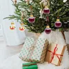 Christmas tree with ornaments and gifts underneath. Produktbild-Vorschau