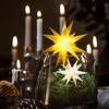 A festive table setting with candles and Christmas decorations. Produktbild-Vorschau