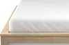 A close-up view of a white fitted sheet on a wooden bed frame. Náhled obrázku produktu