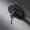 A black shower mixer tap mounted on a textured gray wall. Produktbild-Vorschau