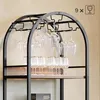 A wine rack with glasses hanging and bottles on shelves. Anteprima dell’immagine prodotto