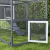 A close-up view of a wooden chicken coop with a ramp and a white door, set on green grass with a hedge in the background. Produktbild-Vorschau