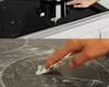 A collage showing a person using an induction cooktop and a close-up of a hand using a glass scraper on a cooktop. Náhľad obrázku produktu