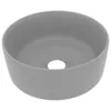 A gray ceramic sink with a hole in the center, shown from a slightly elevated angle against a white background.
