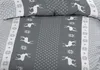 A close-up view of grey bedding with a reindeer and snowflake pattern. Produktbild-Vorschau