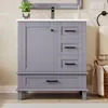 A gray bathroom vanity with a white countertop and black hardware, set against a light beige wall. Anteprima dell’immagine prodotto